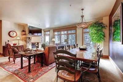 a kitchen and dining room with a table and chairs at Ski In, Ski Out 3 Bedroom At Lone Eagle In River Run in Dillon