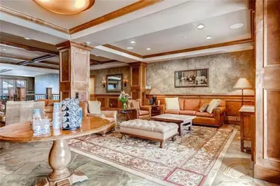 a living room with a couch and a table at Ski In, Ski Out 3 Bedroom At Lone Eagle In River Run in Dillon