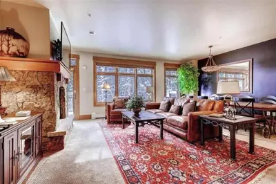 a living room with a couch and a fireplace at Ski In, Ski Out 3 Bedroom At Lone Eagle In River Run in Dillon