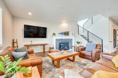 a living room with leather furniture and a fireplace at Berthoud Home with Fire Pit, Close to Lake Loveland! in Berthoud