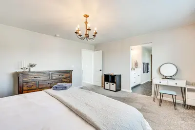 a bedroom with a bed and a desk and a mirror at Berthoud Home with Fire Pit, Close to Lake Loveland! in Berthoud