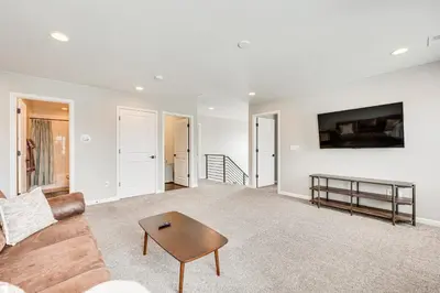 a living room with a couch and a table at Berthoud Home with Fire Pit, Close to Lake Loveland! in Berthoud