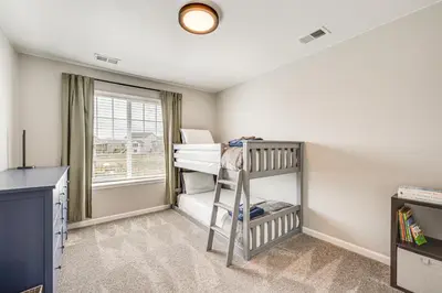 a bedroom with two bunk beds and a window at Berthoud Home with Fire Pit, Close to Lake Loveland! in Berthoud