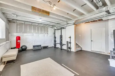 an empty room with a gym with a white wall at Berthoud Home with Fire Pit, Close to Lake Loveland! in Berthoud