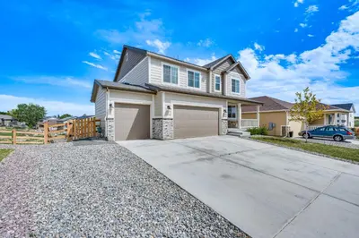 a house with a driveway in front of it at Berthoud Home with Fire Pit, Close to Lake Loveland! in Berthoud