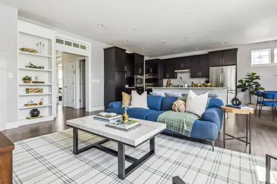 a living room with a blue couch and a table at Modern Elegance - Pool Table - Walkable Area in Aurora