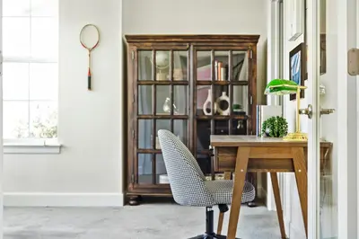 a dining room with a table and a glass cabinet at Modern Elegance - Pool Table - Walkable Area in Aurora