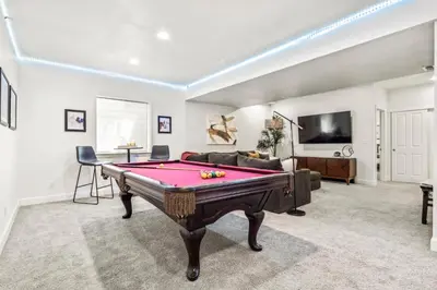 a living room with a pool table and a tv at Modern Elegance - Pool Table - Walkable Area in Aurora