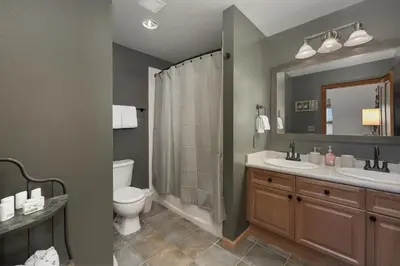 a bathroom with two sinks and a toilet and a mirror at Select Unit 1709 - 2BR - Zephyr Mountain Lodge condo in Winter Park