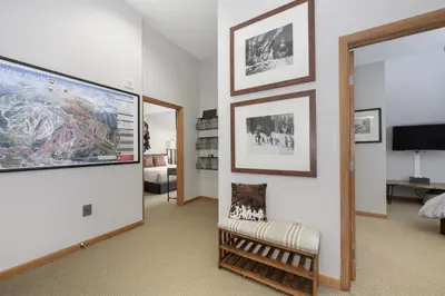 a living room with a large projection screen on the wall at Select Unit 1709 - 2BR - Zephyr Mountain Lodge condo in Winter Park