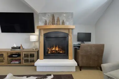 a fireplace in a living room with a fire in it at Select Unit 1709 - 2BR - Zephyr Mountain Lodge condo in Winter Park