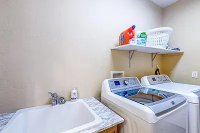 a laundry room with a washing machine and a sink at Mountain Sky Retreat in Granby