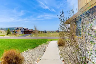 a sidewalk next to a building with a house at Mountain Sky Retreat in Granby