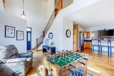 a living room with a foosball table at Mountain Sky Retreat in Granby