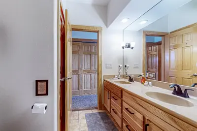 a bathroom with two sinks and a large mirror at Mountain Sky Retreat in Granby