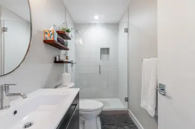 a white bathroom with a sink and a toilet at LuxuryDenver Studio w Hot Tub 2 Mi to Downtown in Denver