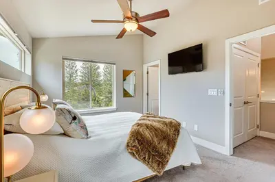 a bedroom with a bed and a ceiling fan at Walk to Dtwn Fraser Retreat with Hot Tub and Views! in Winter Park