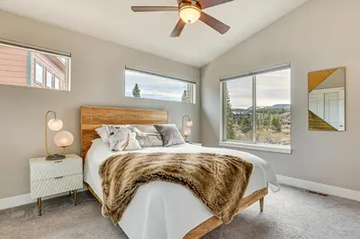 a bedroom with a bed and a ceiling fan at Walk to Dtwn Fraser Retreat with Hot Tub and Views! in Winter Park
