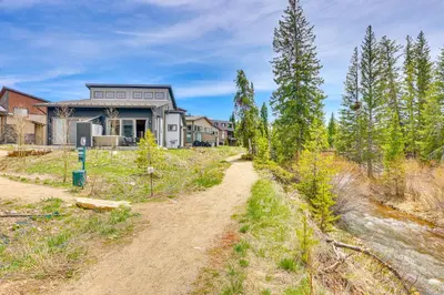 a house on a hill with a dirt road at Walk to Dtwn Fraser Retreat with Hot Tub and Views! in Winter Park