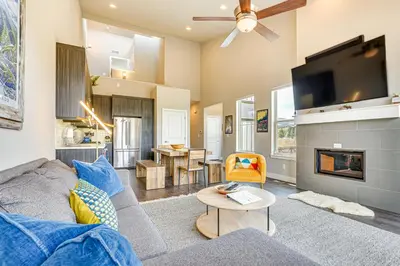 a living room with a couch and a tv at Walk to Dtwn Fraser Retreat with Hot Tub and Views! in Winter Park