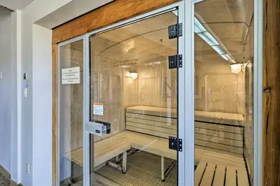 a glass door to a cell with two benches inside at Fraser Mountain Retreat with Resort Amenities! in Fraser