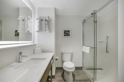 a white bathroom with a toilet and a sink at Hampton Inn Aurora Medical Center Denver in Aurora