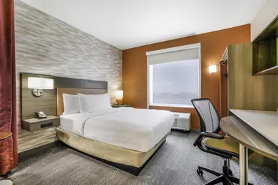 a hotel room with a bed and a desk at Home2 Suites By Hilton Aurora Medical Center Denver in Aurora