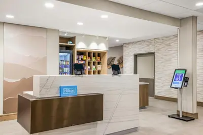 a lobby of a pharmacy with a cash counter at Home2 Suites By Hilton Aurora Medical Center Denver in Aurora