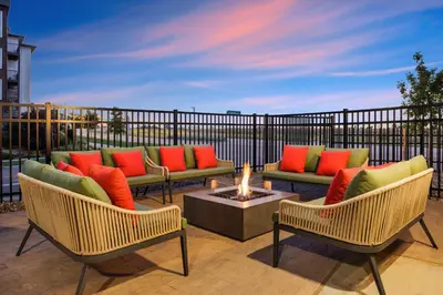 a patio with couches and a fire pit at Home2 Suites By Hilton Aurora Medical Center Denver in Aurora
