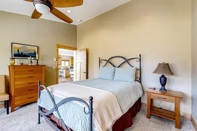 a bedroom with a bed and a dresser at Winter Park Ski & Summer Retreat in Fraser