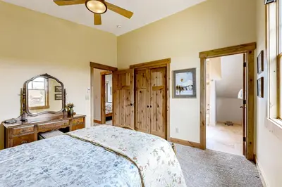 a bedroom with a bed and a mirror and a dresser at Winter Park Ski & Summer Retreat in Fraser