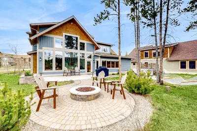 a patio with chairs and a fire pit in front of a house at Winter Park Ski & Summer Retreat in Fraser