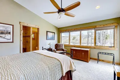 a bedroom with a bed and a ceiling fan at Winter Park Ski & Summer Retreat in Fraser