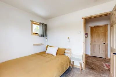a bedroom with a bed and a chair in it at Hytta Hyggelig in Tabernash