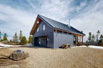 a barn with a picnic table in front of it at Hytta Hyggelig in Tabernash