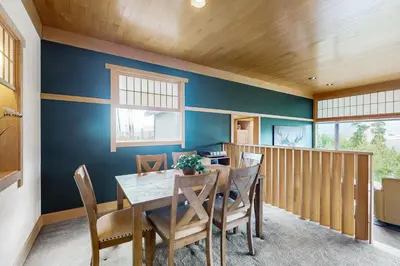 a dining room with blue walls and a table and chairs at Mountain Minka in Grand Lake