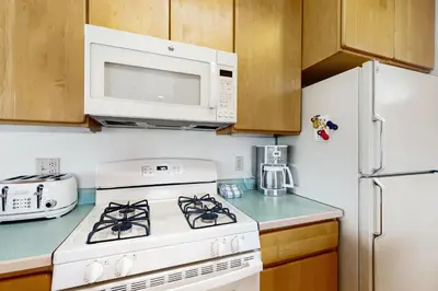 a kitchen with a white stove and a microwave at Mountain Minka in Grand Lake