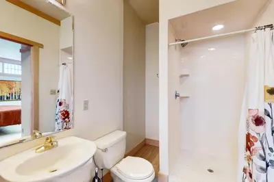 a bathroom with a sink and a toilet and a shower at Mountain Minka in Grand Lake