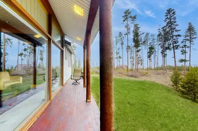 an open porch of a house with a chair on it at Mountain Minka in Grand Lake