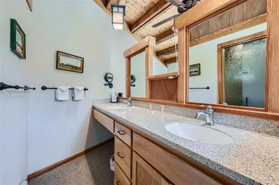 a bathroom with a sink and a mirror at 2024 Homestead condo in Keystone