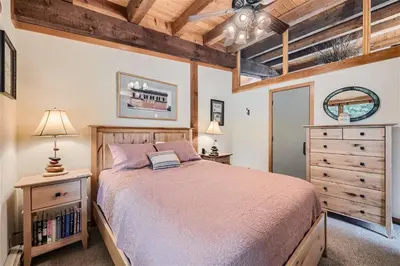 a bedroom with a bed and a wooden ceiling at 2024 Homestead condo in Keystone
