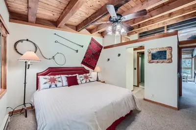 a bedroom with a bed and a ceiling fan at 2024 Homestead condo in Keystone