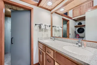 a bathroom with two sinks and a mirror at 2024 Homestead condo in Keystone