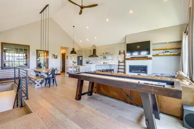 a large living room with a ping pong table at Hot Tub and Mtn Views Townhome in Granby! in Granby