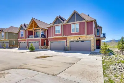 a large red house with two garage at Hot Tub and Mtn Views Townhome in Granby! in Granby
