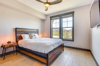 a bedroom with a large bed and a window at Hot Tub and Mtn Views Townhome in Granby! in Granby