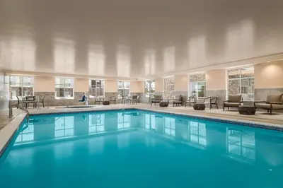 a large pool with blue water in a hotel room at Homewood Suites By Hilton Thornton Denver in Thornton