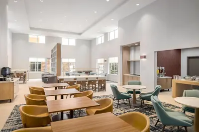 a classroom with tables and chairs and a cafeteria at Homewood Suites By Hilton Thornton Denver in Thornton