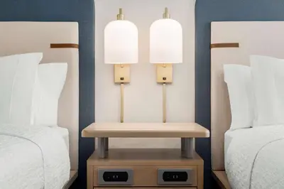 a room with two beds and two lights between them at Homewood Suites By Hilton Thornton Denver in Thornton