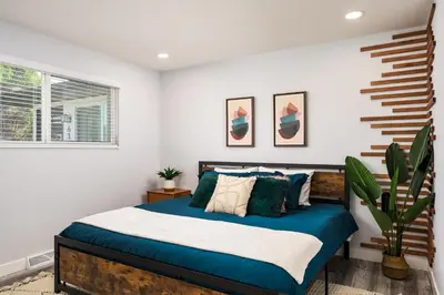 a bedroom with a bed with blue and white sheets at Denver Emerald - Close to Red Rocks, Arvada & Downtown in Denver